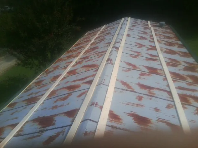 Rusted metal roof panels with new wood purlins before replacement — Storm Damage Roof Repair in Anadarko by Roofing Brothers